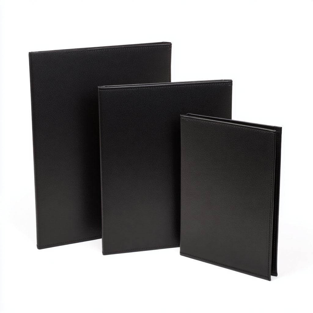 Three black menu covers of varying sizes on a white background