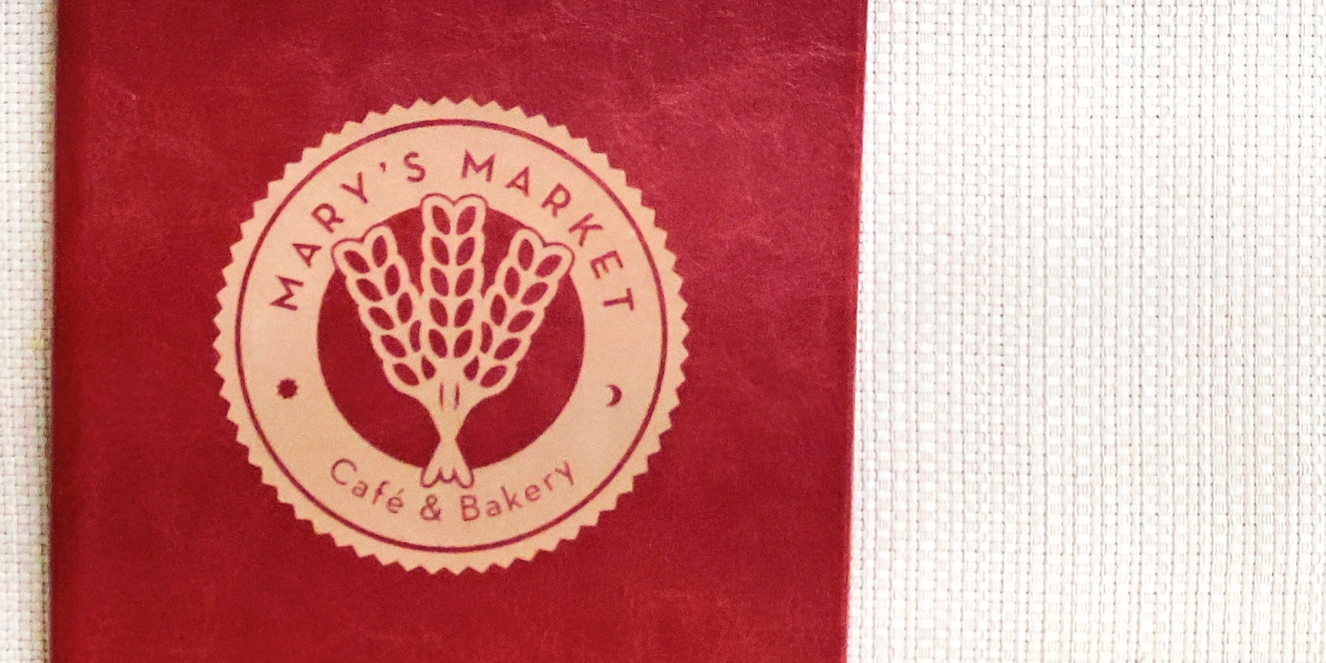 Red menu with 'Mary's Market Cafe & Bakery' logo on a textured red background