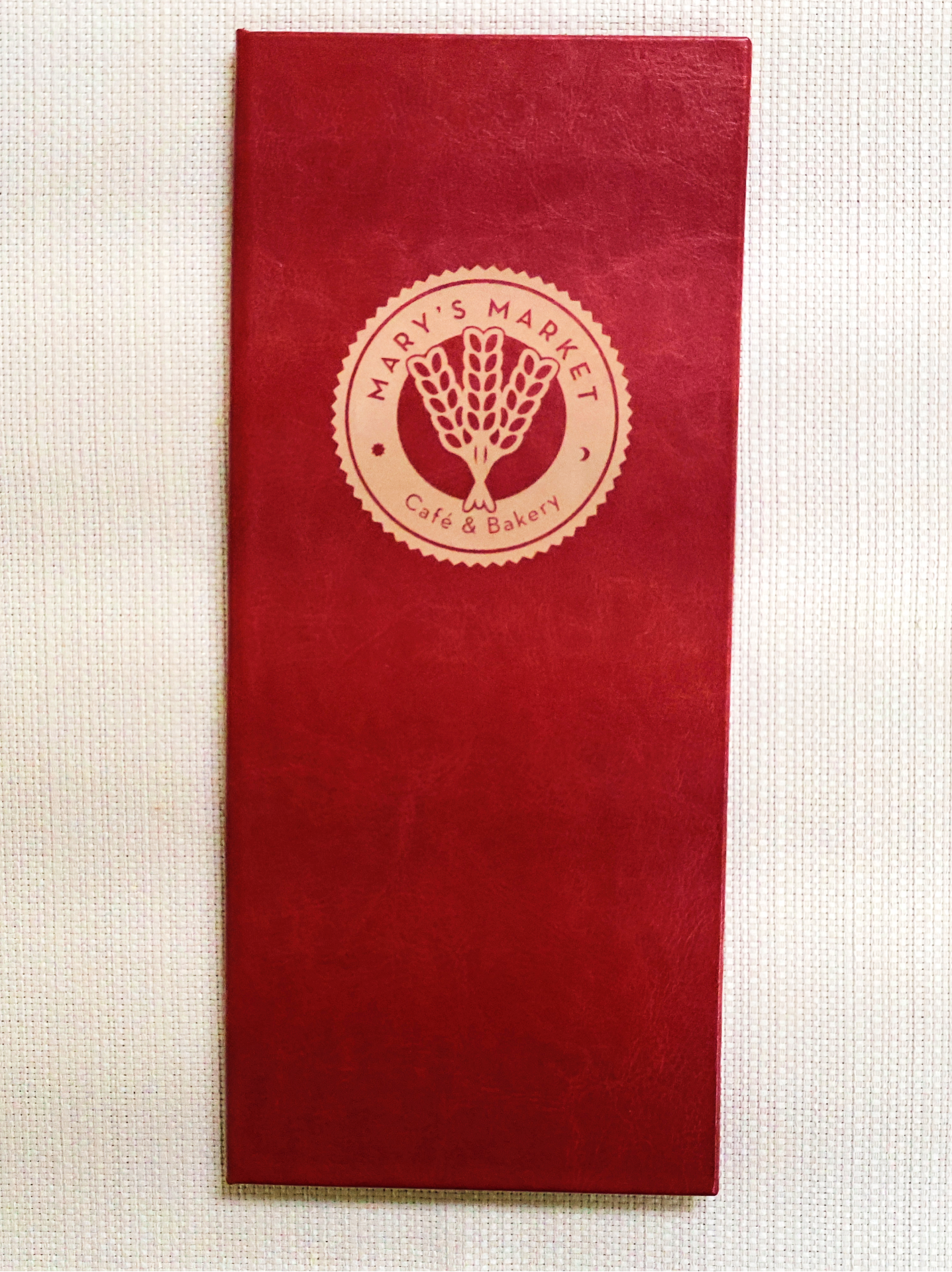 Red menu cover with 'Mary's Market Cafe & Bakery' logo on a white background