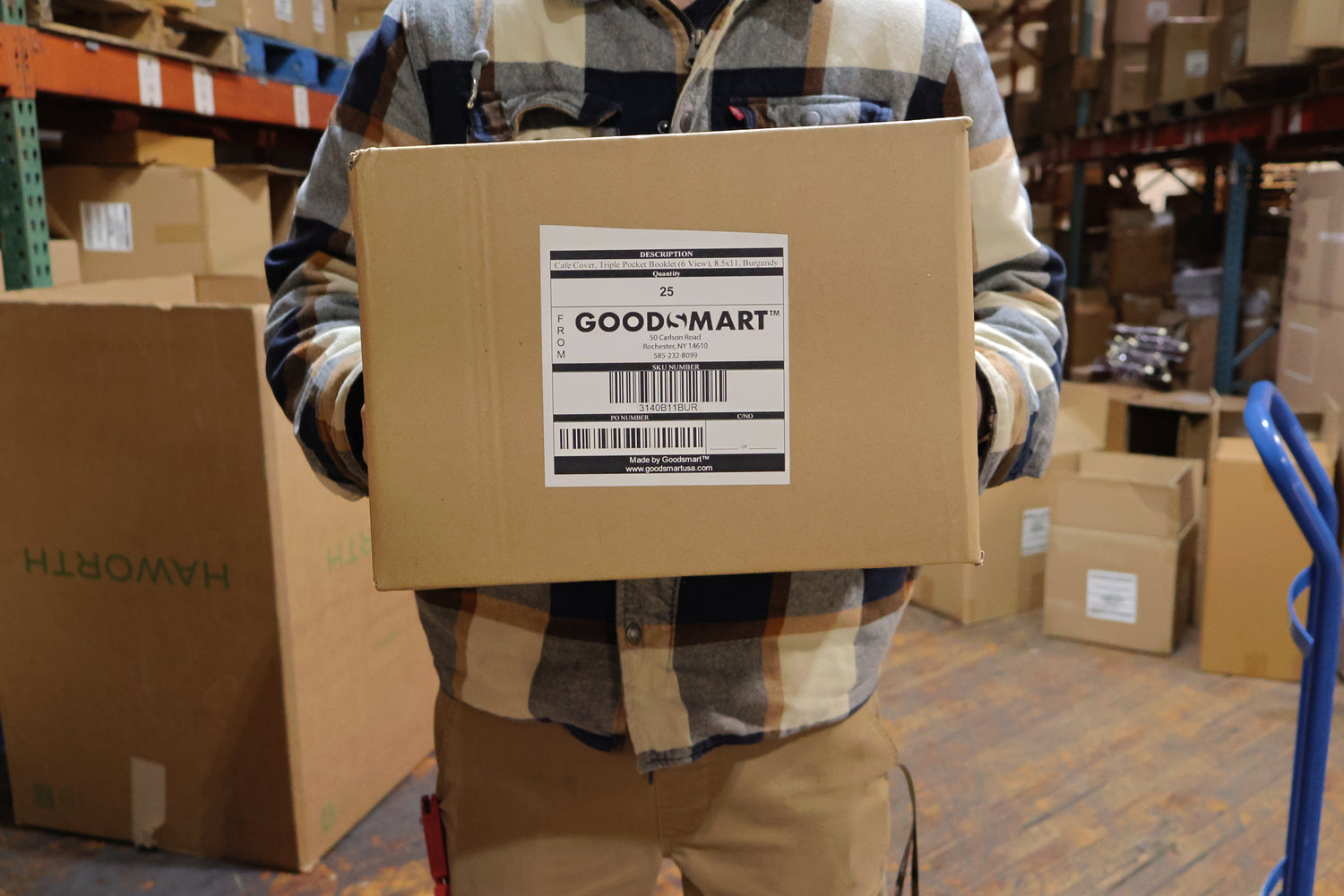 Man holding a box of menu covers ready to be shipped